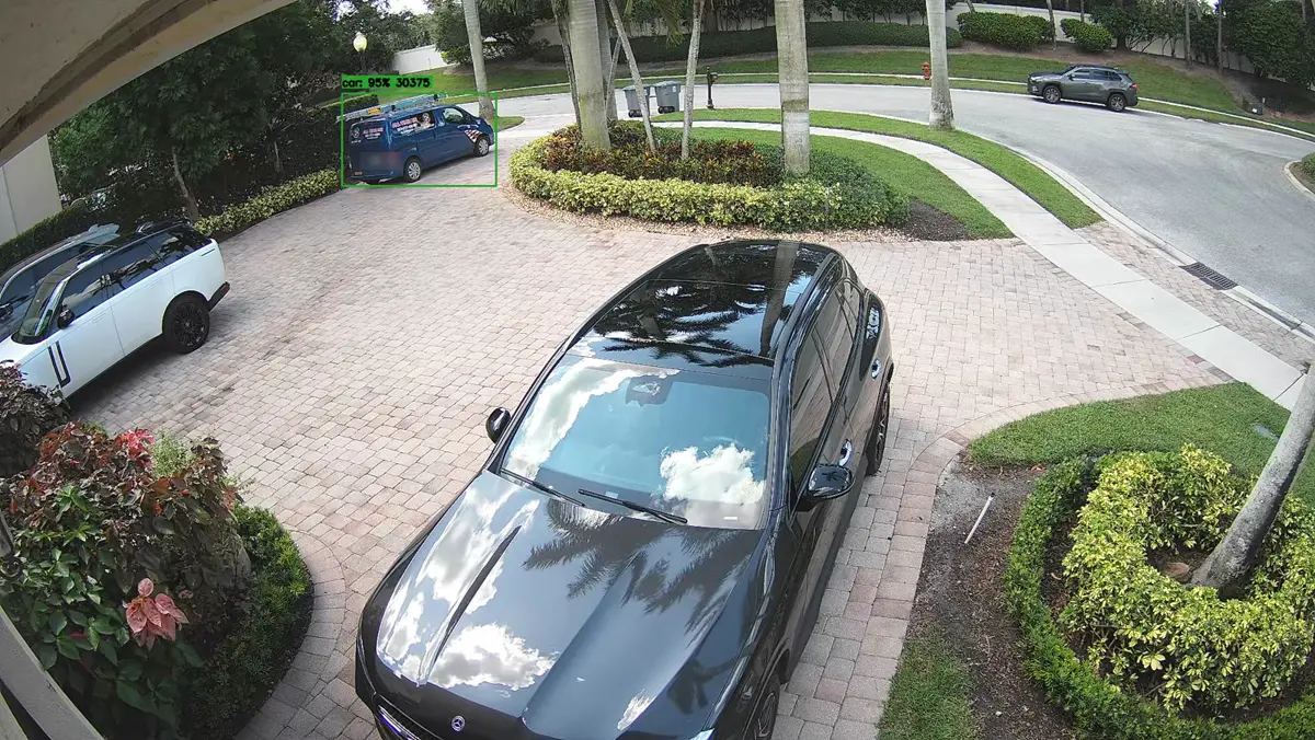 Recorder snapshot of a blue service van entering a paver driveway, with the AI detection box around the van